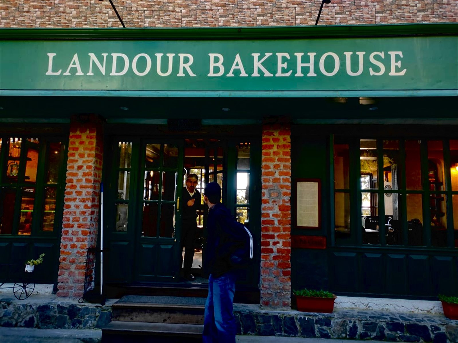 The Landour Bakehouse sign above its green and brick storefront.